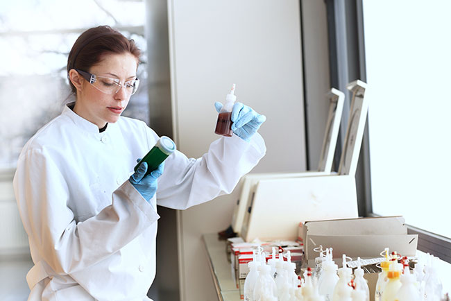 Young Female Scientist At Work In Lab